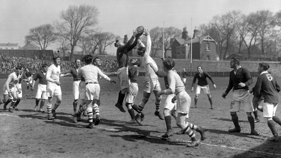 Lt Eyres, Captain of the Devonport Services team gets possession from a line out in a match against the USA Olympic Rugby team who won the gold medal in the 1924 Paris Olympics. The USA team won by 25 points to three. 