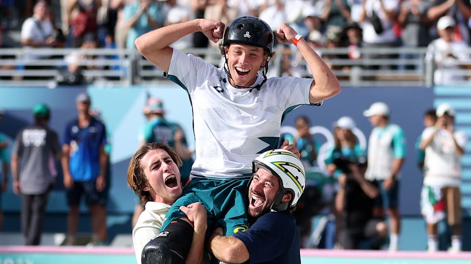  Gold medalist Keegan Palmer of Team Australia (C) celebrates rise by Tate Carew of Team United States (L) and Pedro Barros of Team Brazil during the Men's Park Final 