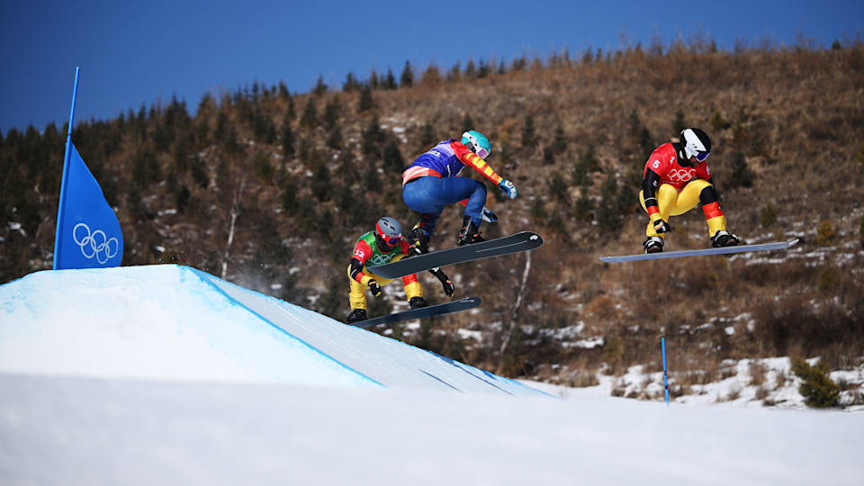 Paul Berg of Team Germany, Lucas Eguibar of Team Spain and Martin Noerl of Team Germany compete during the Men's Snowboard Cross 18 finals on Day 6 of the Beijing 2022