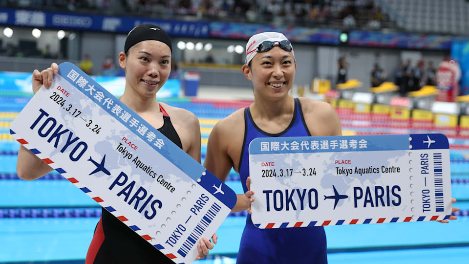 Reona Aoki (L) and Satomi Suzuki celebrates qualifying for the Paris 2024 Olympic Games after competing in the Women's 100m Breaststroke Final