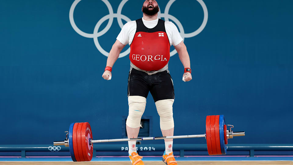 Georgia's Lasha Talakhadze became a 3-time Olympic champion after clinching his third gold in the men's +102kg weightlifting event | Paris 2024 Weightlifting Results | Mania Sports