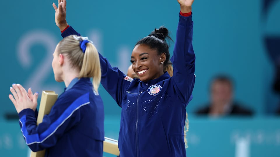 Gold medalist Simone Biles of Team United States celebrates on the podium during the medal ceremony for the Artistic Gymnastics Women's Vault Final