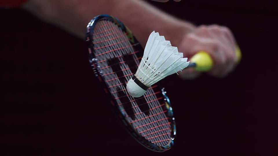 A racket and shuttlecock during a service during Badminton.