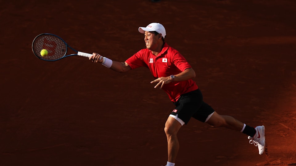 Kei Nishikori of Team Japan plays a forehand shot with partner (out of frame) Taro Daniel of Team Japan against Dan Evans and Andy Murray of Team Great Britain during the Menâ€™s Doubles first round match on day two of the Olympic Games Paris 2024 at Roland Garros on July 28, 2024 in Paris, France.