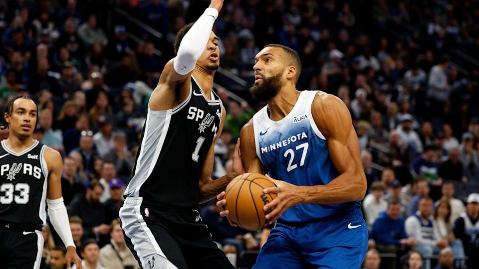 Rudy Gobert #27 of the Minnesota Timberwolves goes to the basket against Victor Wembanyama #1 of the San Antonio Spurs