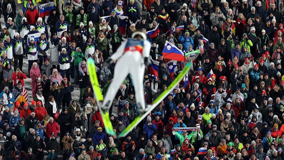 General view as spectators watch Nika Vodan of Team Slovenia compete in the Mixed Team First Round on day four of the Milano Cortina 2026 Winter Olympic games at Predazzo Ski Jumping Stadium on February 10, 2026 in Val di Fiemme, Italy.