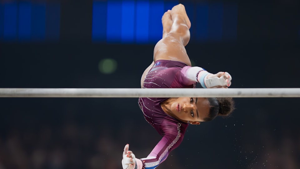 A gymnast in action on a bar