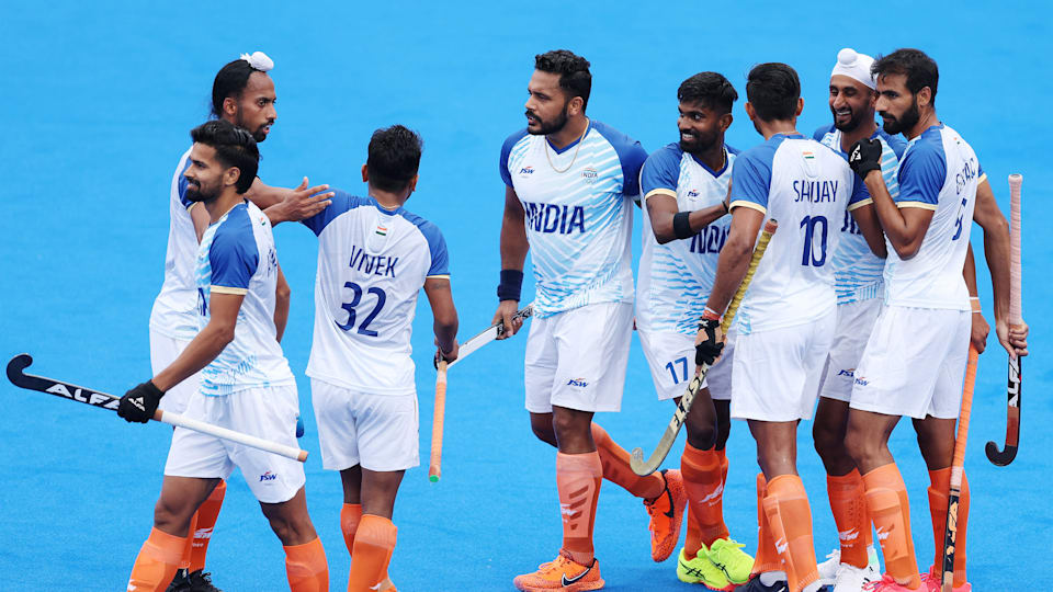 Mandeep Singh of Team India (2R) celebrates scoring his team's first goal.