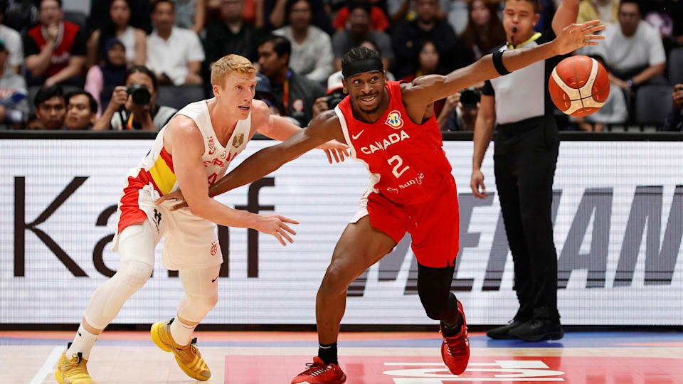 Canada's game-winner Shai Gilgeous-Alexander (R) tussles with Spain's Alberto Diaz