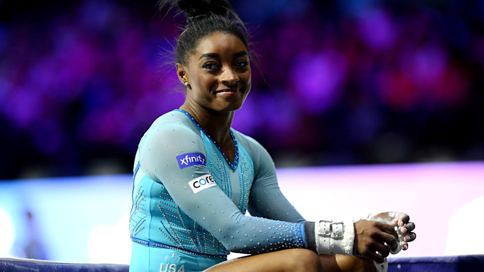 Simone Biles smiles after her uneven bars routine in qualification at the 2023 World Artistic Gymnastics Championships
