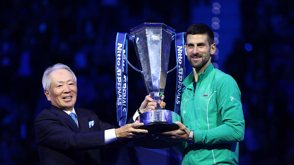 Novak Djokovic receives the ATP Finals trophy after his triumph in Turin