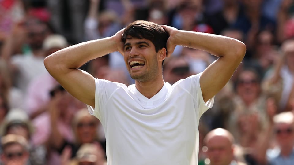 Alcaraz holds his hands to his head and smiles broadly after sealing victory.