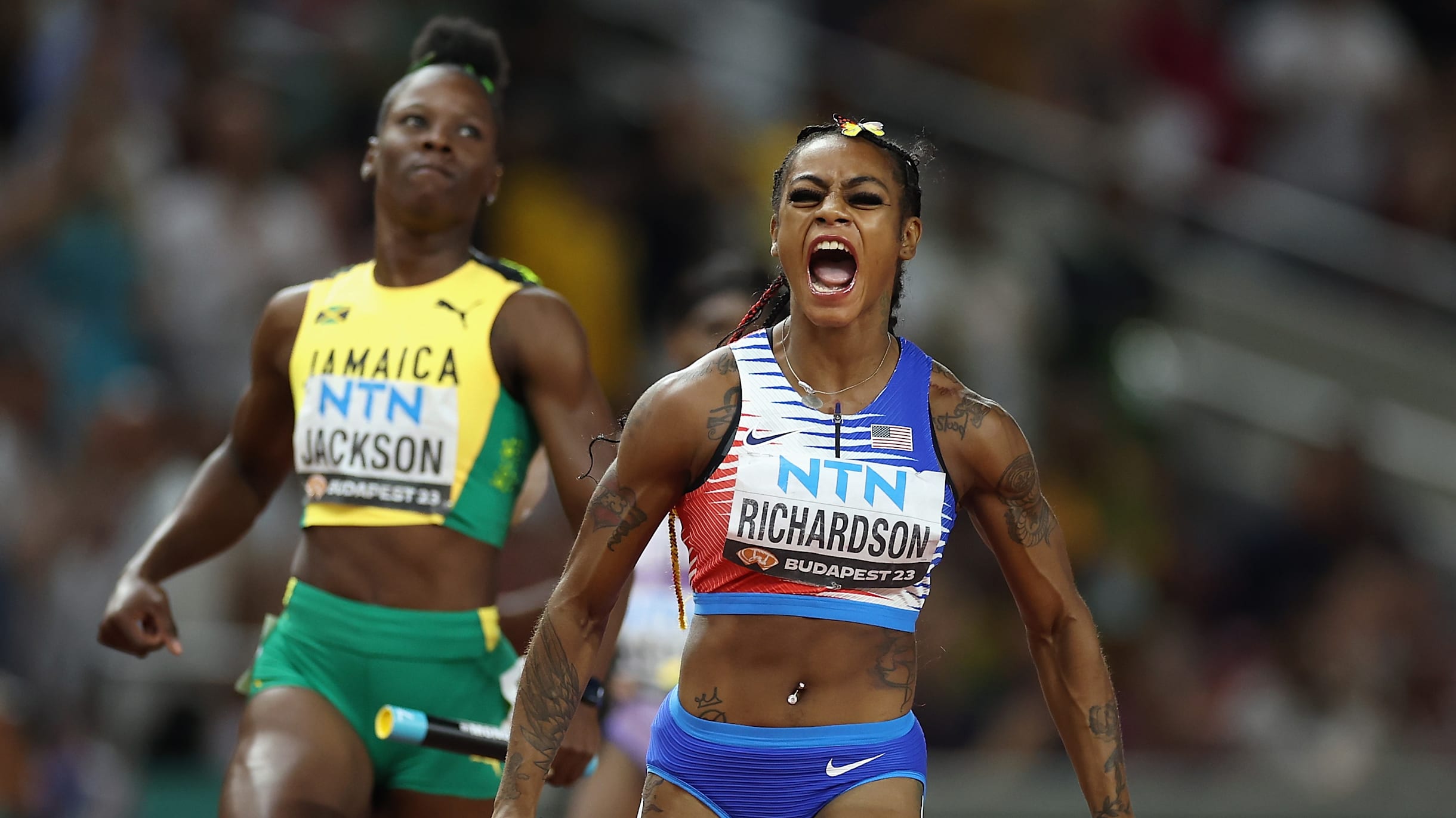 Group Of Women Athletes Running In Stadium During Athletics