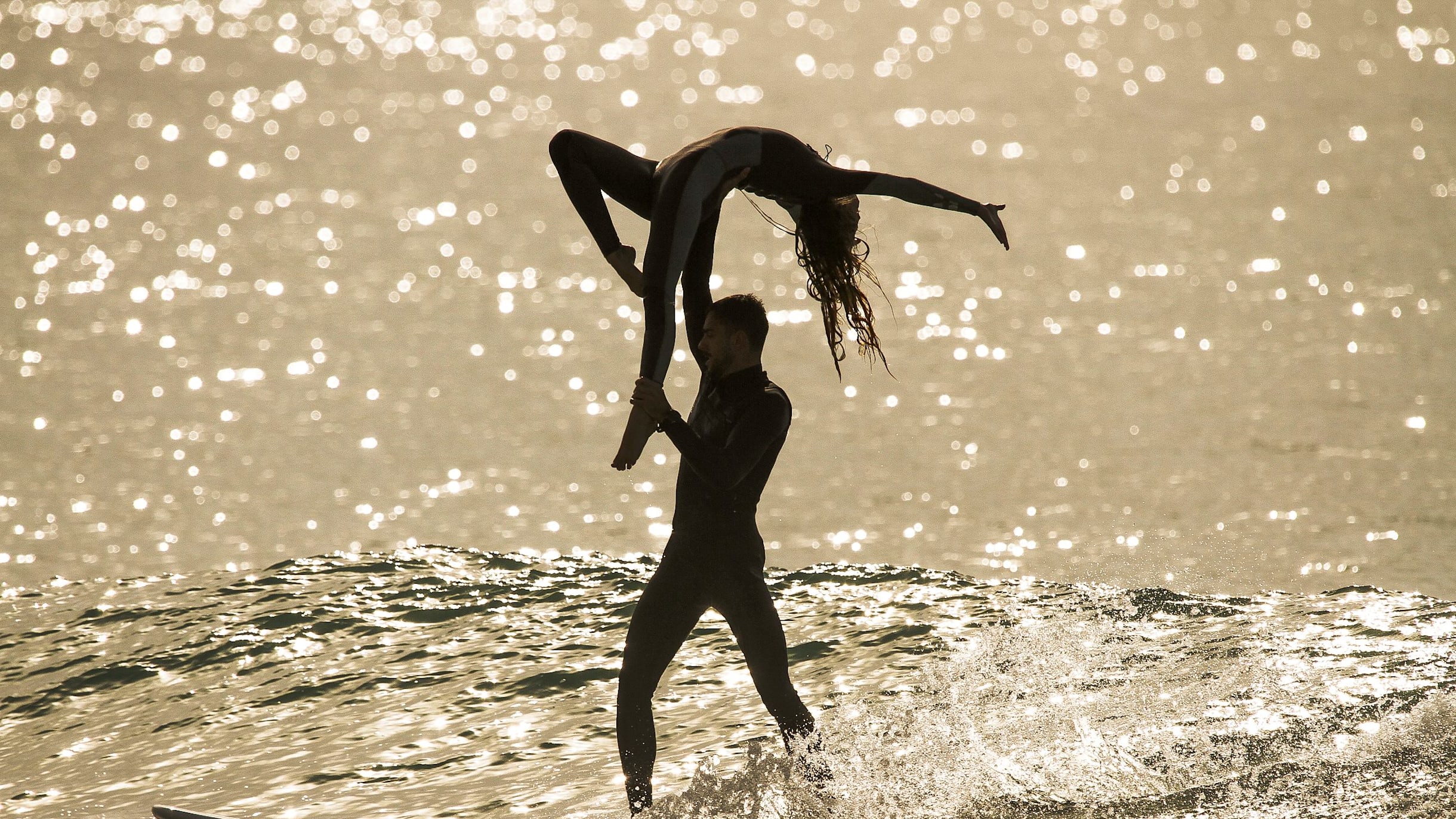 Two surfers, one board, a sequence of acrobatic lifts: Nicole