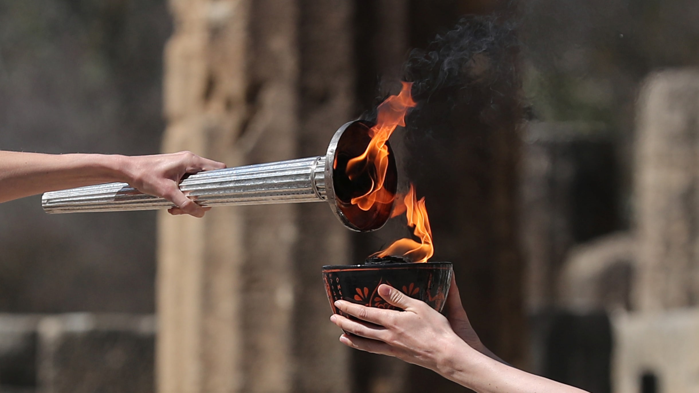 olympic torch logo with hands