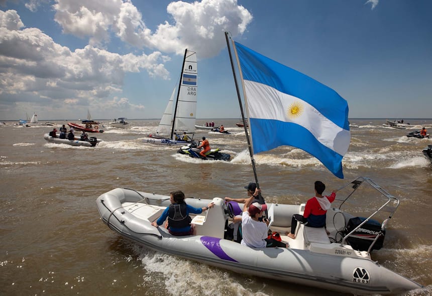 An armada of fans escort Dante Cittadini and Teresa Romairone (ARG) after their victory off the Club Nautico San Isidro (Gabriel Heusi for OIS/IOC)