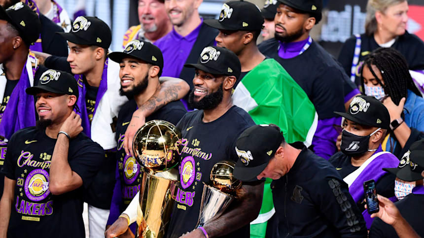  LeBron James of the Los Angeles Lakers reacts with his MVP trophy and Finals trophy after winning the 2020 NBA Championship over the Miami Heat 