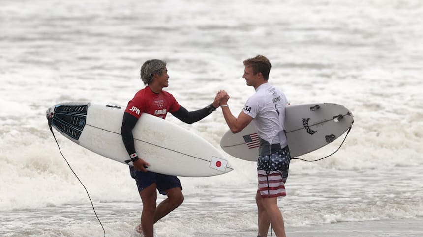 (Surfer in red) Kanoa Igarashi of Team Japan embraces Kolohe Andino of Team United States after Kanoa's win in their men's Quarter Final on day four of the Tokyo 2020 Olympic Games at Tsurigasaki Surfing Beach on July 27, 2021 in Ichinomiya, Chiba, Japan. 