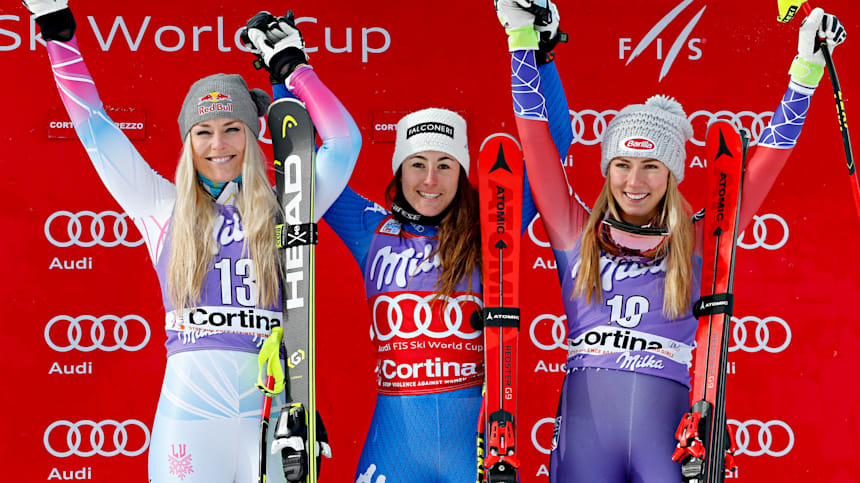 Lindsey Vonn (L) and Mikaela Shiffrin (R) share the podium with Sofia Goggia (M) during the World Cup downhill event in Cortina d'Ampezzo on 19 January 2018.