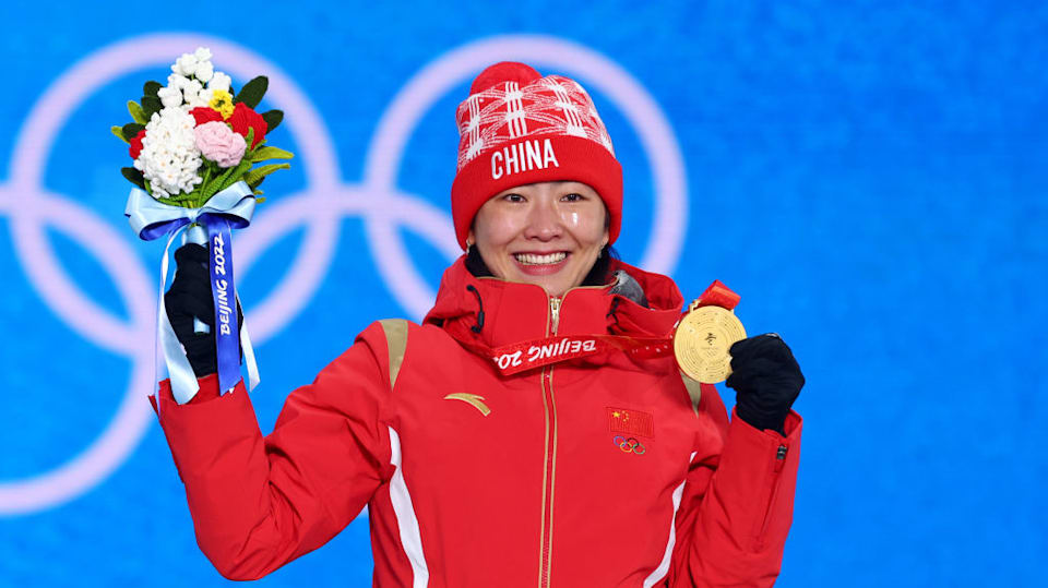 Olympic Skier & Model Eileen Gu Poses With Her Gold Medals in Red