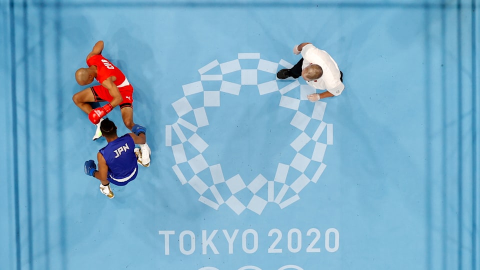 Roniel Iglesia (red) of Cuba is knocked down by Sewonrets Quincy Mensah Okazawa of Japan during the Meen's Welter (63-69kg) on day four of the Tokyo 2020 Olympic Games at Kokugikan Arena on July 27, 2021 in Tokyo, Japan.