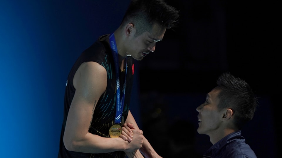 2019 Malaysia Open champion Lin Dan on the podium congratulated by Lee Chong Wei