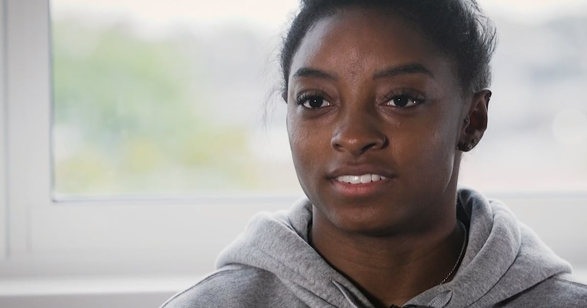 Simone Biles in the doghouse to raise awareness for abandoned animals