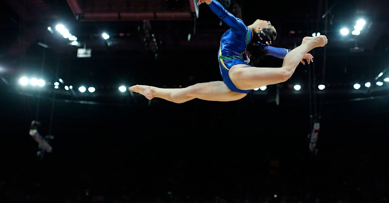 Team Brazil competes on the balance beam during qualifying at the 2012 ...